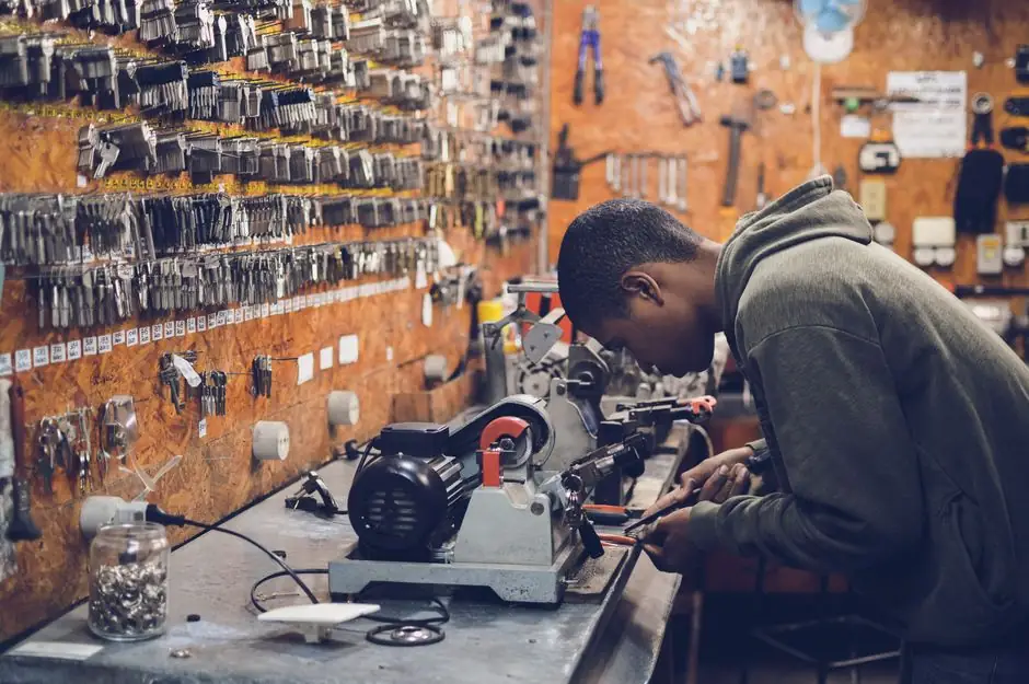 Locksmith cutting a duplicate key on a key machine in Waxhaw, NC